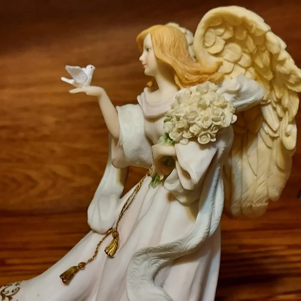 BEAUITFUL ANGLE HOLDING FLOWERS AND A BIRD IN HER HAND